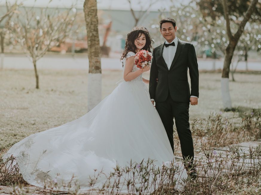 Happy bride and groom in a park during a joyful and loving wedding celebration.